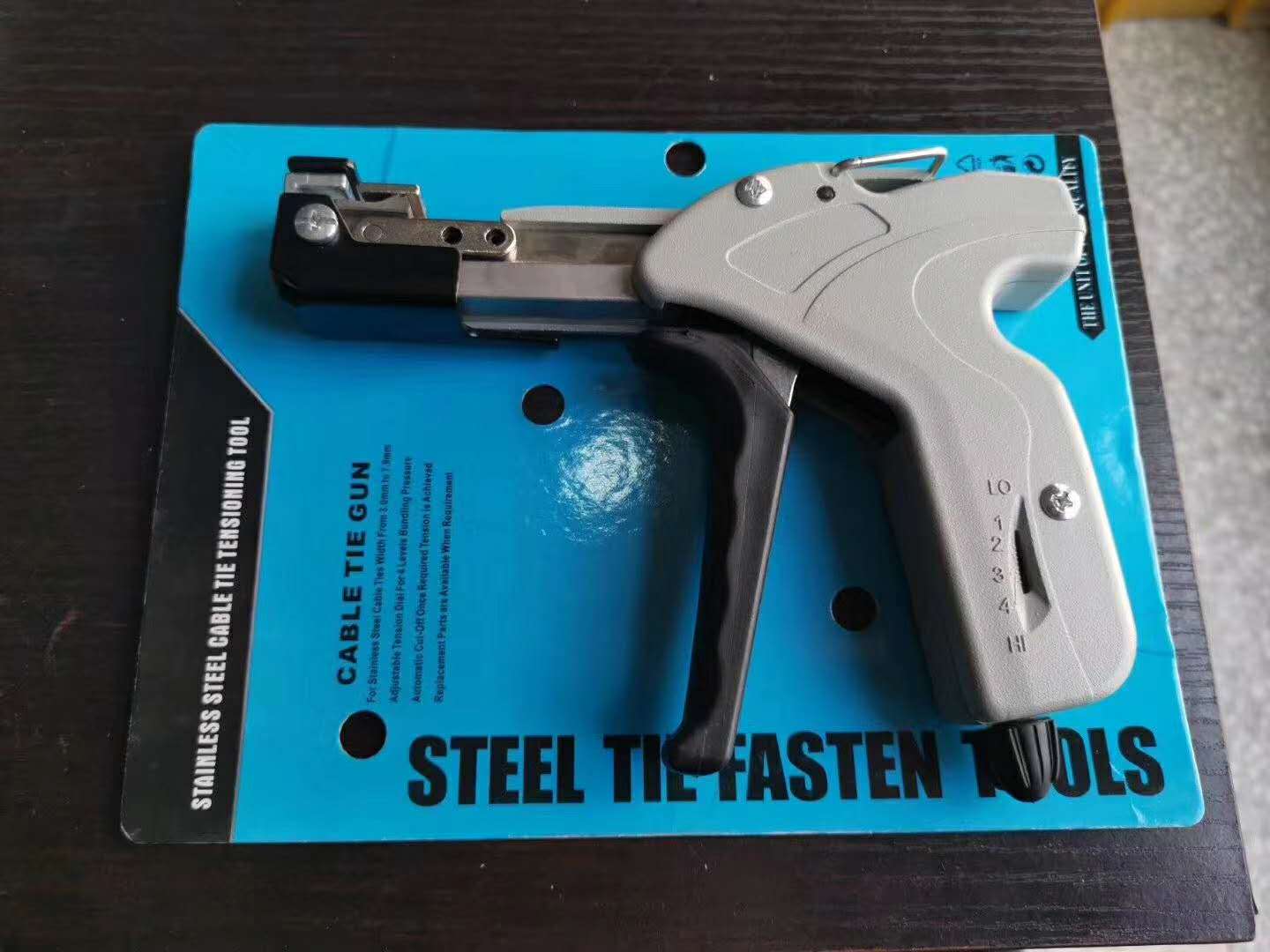 Stainless steel banding tie gun with adjustable handle. 